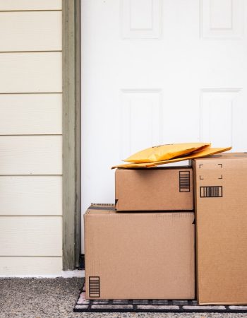 Front Door of House with Stack of Delivery Boxes from Online Ordering and E-commerce